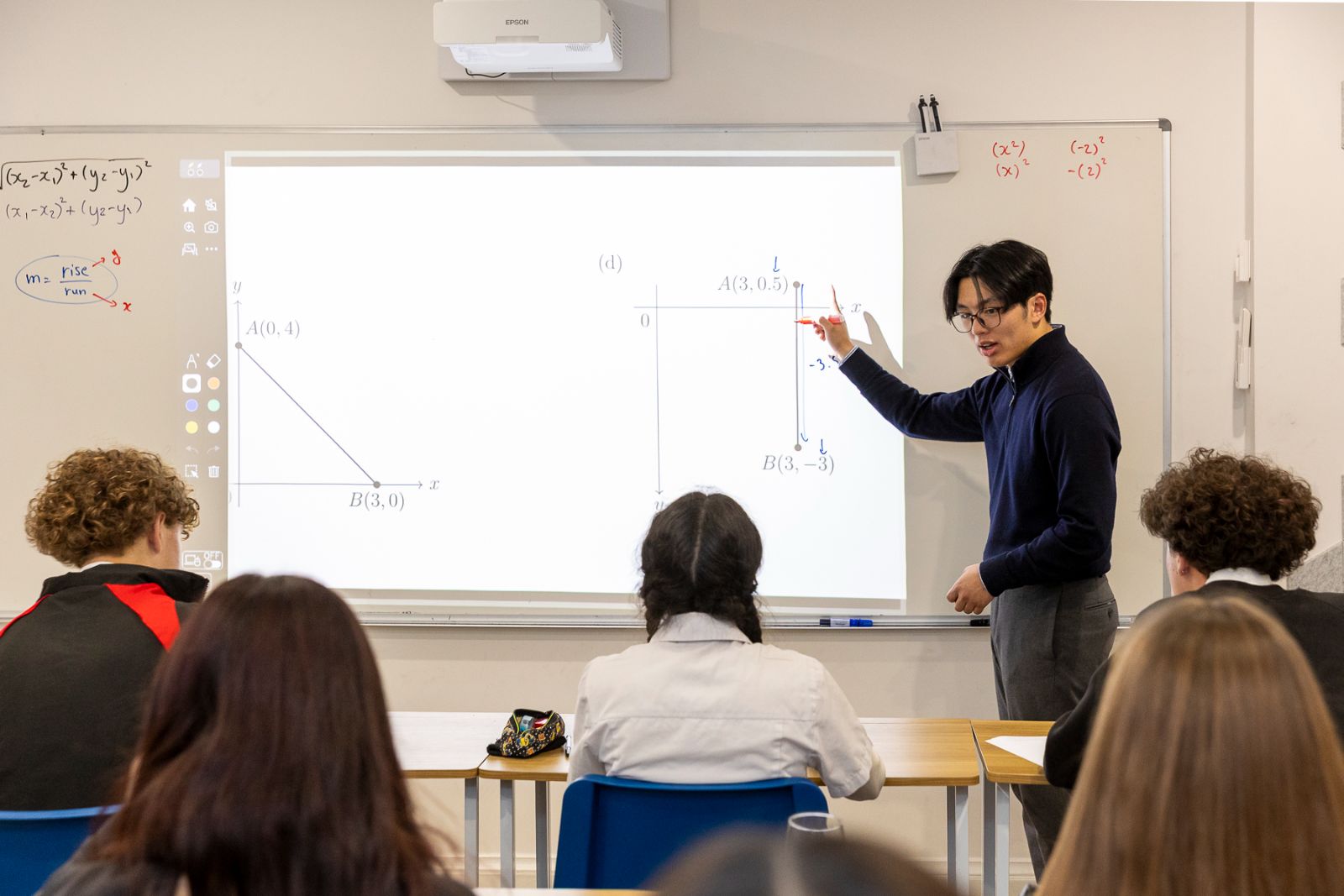 CMC tutor presenting a worked example at the whiteboard
